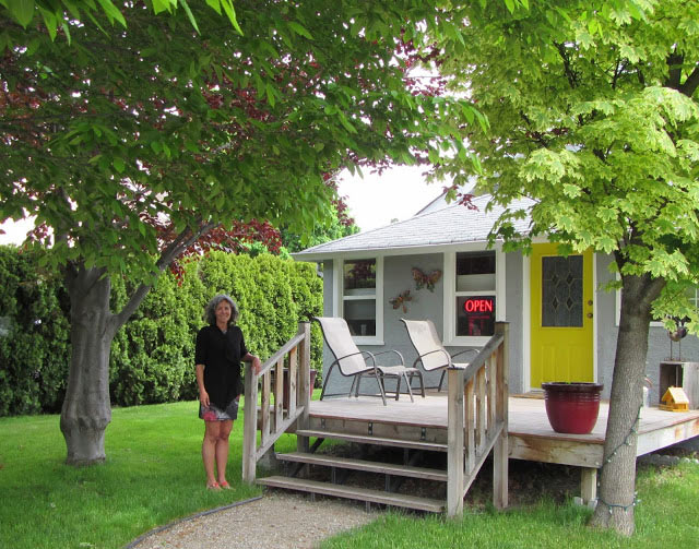 Helene standing in beautifully landscaped private yard outside entrance to the clinic.